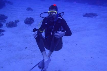 diver sitting on sand bed